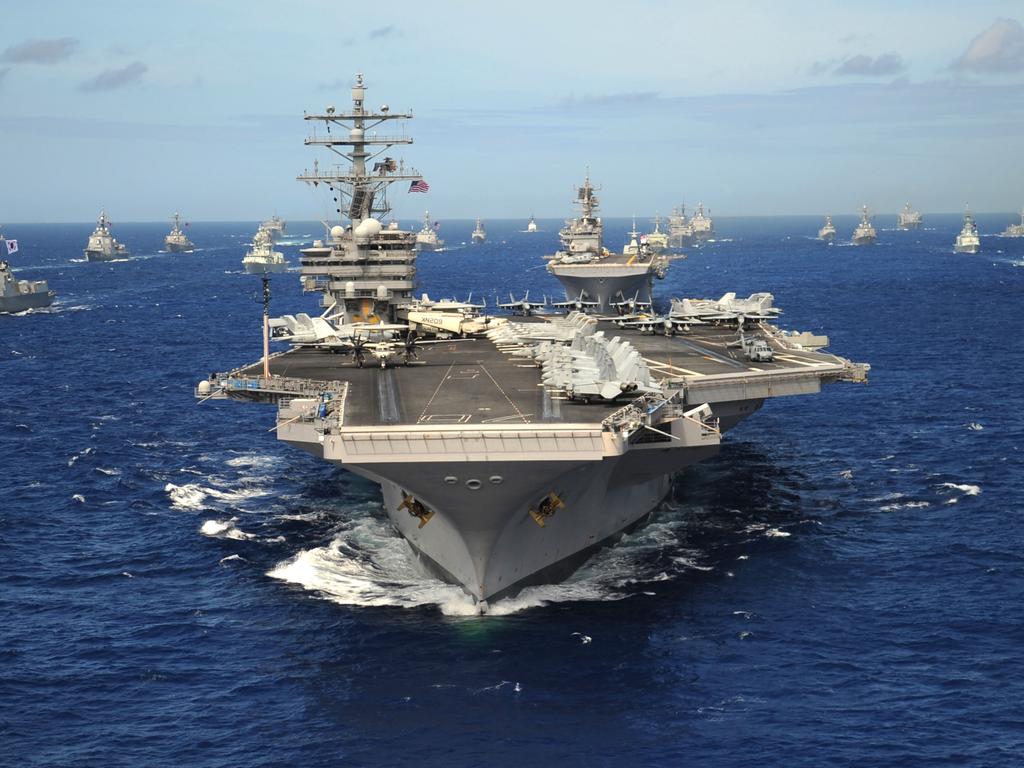 D4NHD2 US Navy Nimitz-class nuclear aircraft carrier USS Ronald Reagan leads a group of multinational ships during RIMPAC exercises in 2010.