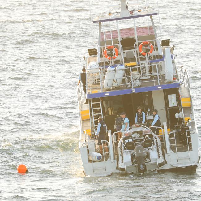 NSW Fisheries officers drop drum lines off Little Bay beach after Wednesday’s fatal shark attack. Picture: John Grainger