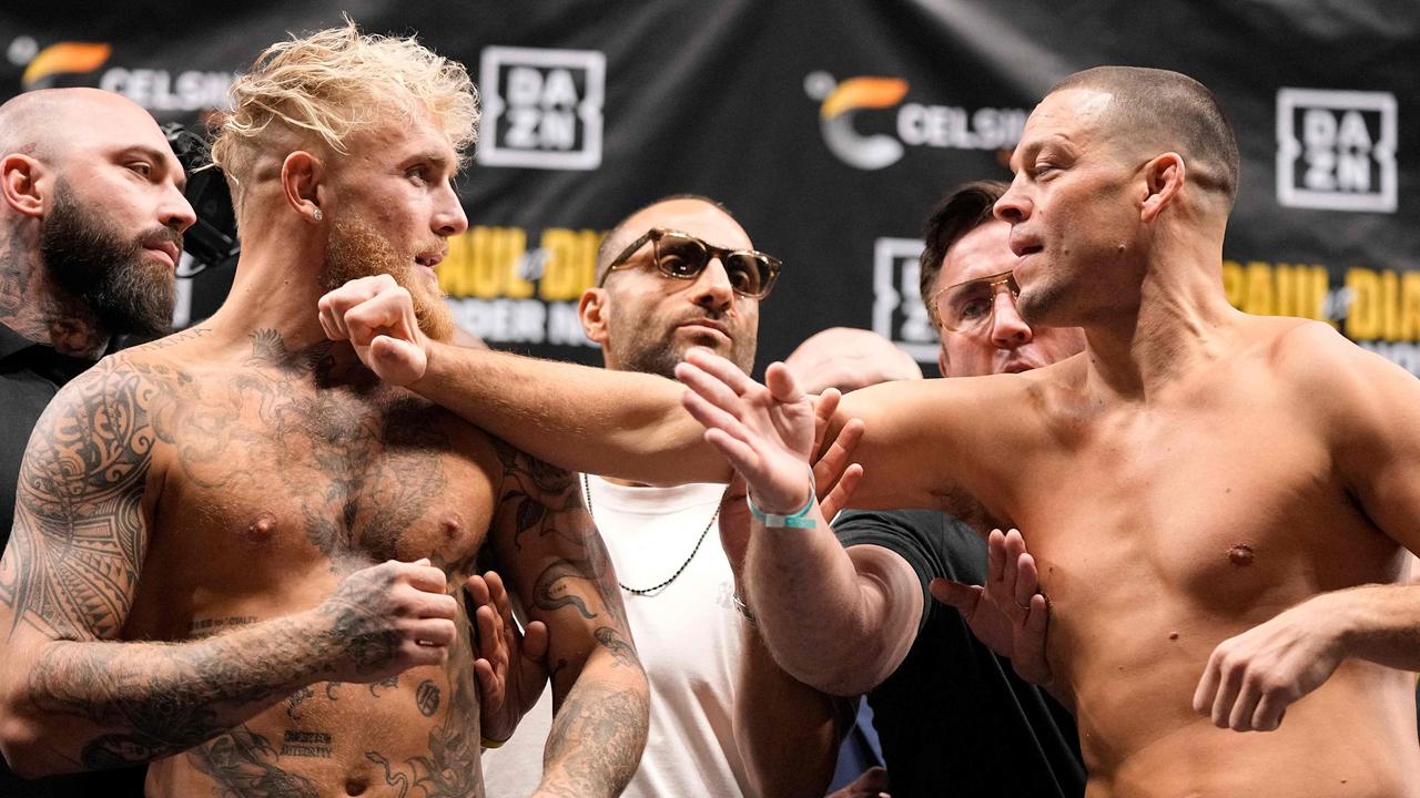 Nate Diaz lunges at Jake Paul during weigh-ins. Photo by Sam Hodde / GETTY IMAGES NORTH AMERICA / Getty Images via AFP.