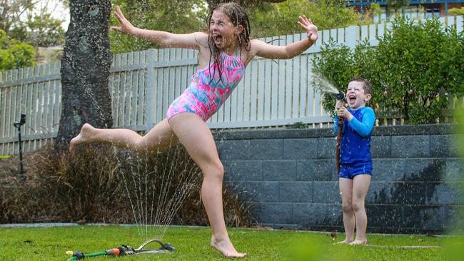 Leila, 10, and Jack, 5, Mayoh enjoy a water fight in their backyard on Monday. Picture: Justin Lloyd.