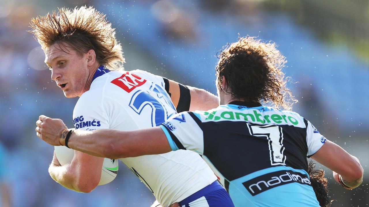 Jacob Preston is tackled by Nicho Hynes during a trial match.