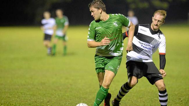 Soccer: Clinton FC's Christopher McDougall and Nerimbera's Michael Cay. Picture: Allan Reinikka ROK160319asoccer5