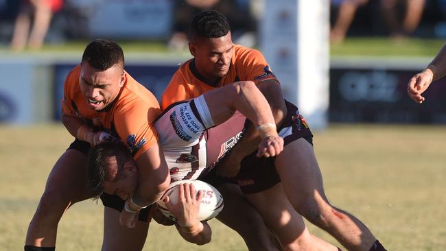 Burleigh's Brett Stratton tacked by Campbell Pirihi. (Photo/Steve Holland)