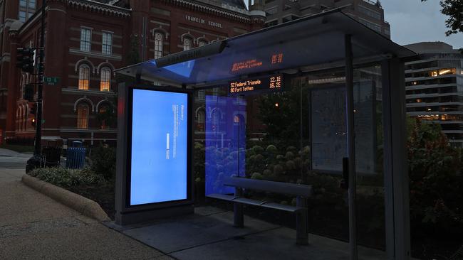 A blue Windows error message caused by the CrowdStrike software update is displayed on a screen in a bus shelter in Washington on July 22. Picture: Getty Images