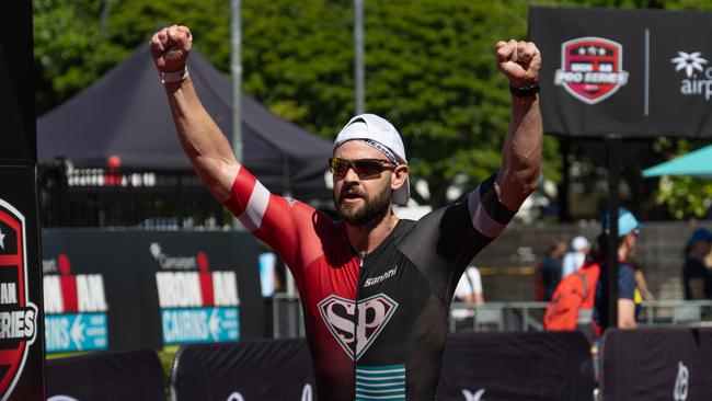 Sam Smith of the UK celebrates his finish during the IRONMAN 70.3 Cairns. Picture Emily Barker.