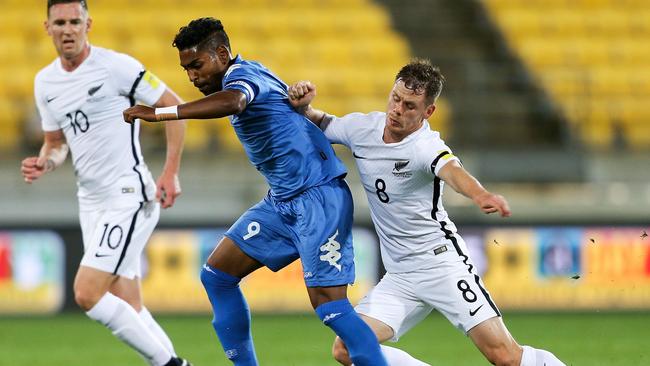 Roy Krishna of Fiji is tackled by Michael McGlinchey of New Zealand