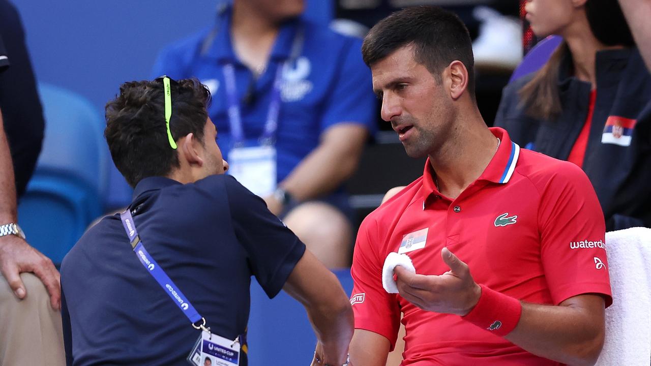 PERTH, AUSTRALIA - JANUARY 03: Novak Djokovic of Team Serbia receives treatment to his right arm during his singles match against Alex de Minaur of Team Australia during day six of the 2024 United Cup at RAC Arena on January 03, 2024 in Perth, Australia. (Photo by Paul Kane/Getty Images)