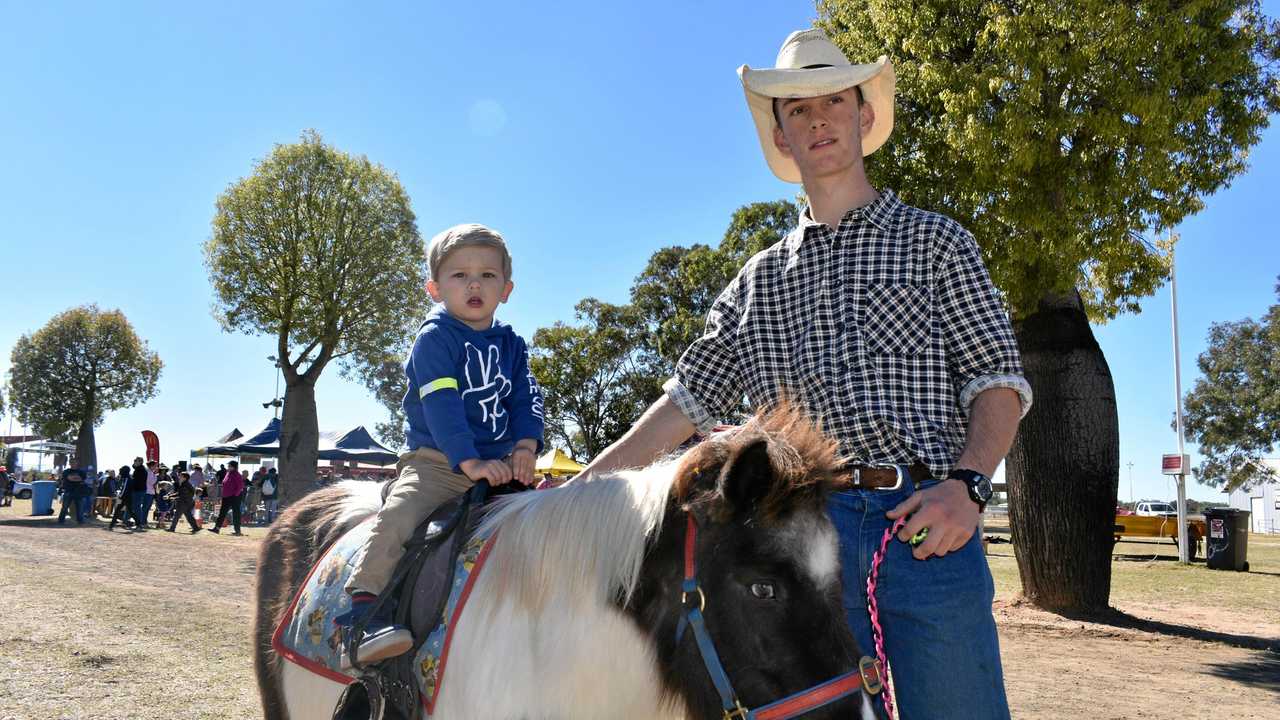 HORSING AROUND: Henry Williamson hitches a ride at last year's Roma Fun Day with Ashley Smith. Picture: Joshua Macree