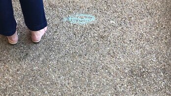 Blue chalk marks on the ground force voters to keep their distance this morning.