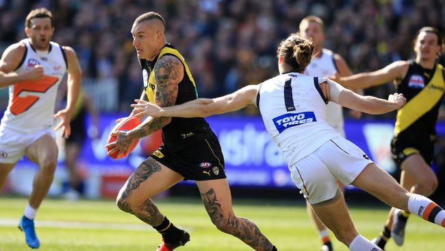 Dustin Martin evades Phil Davis. Picture: Mark Stewart