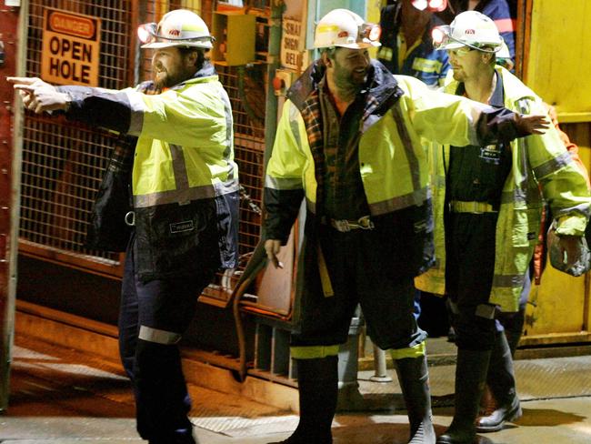 Tasmanian miners Todd Russell (left) and Brant Webb wave as they emerge from the mine lift having been rescued after being trapped underground at Beaconsfield gold mine for 14 days. Picture: AFP