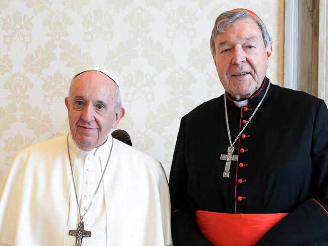 This handout photo taken on October 12, 2020, and released by the Vatican press office, the Vatican Media, shows Pope Francis (L) posing with Australian cardinal George Pell during a private audience at the Vatican. (Photo by Handout / VATICAN MEDIA / AFP)