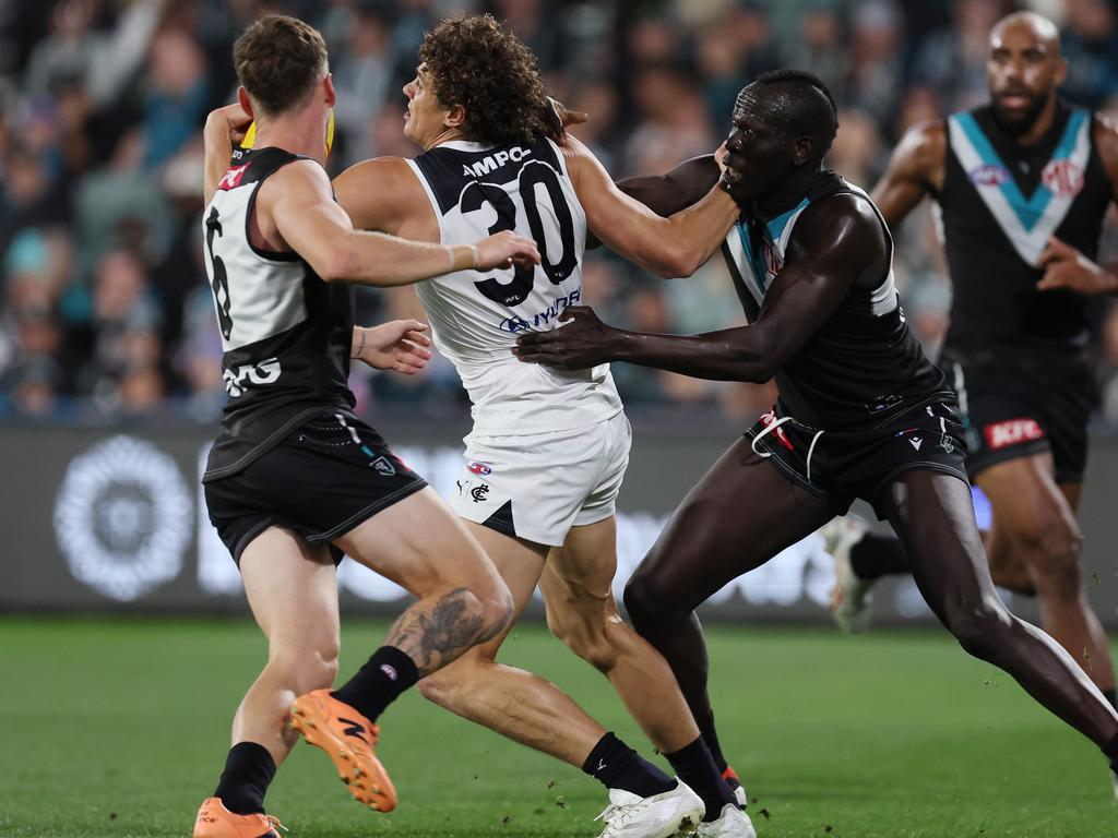 Aliir Aliir and Kane Farrell tackle Charlie Curnow. Picture: James Elsby/AFL Photos via Getty Images