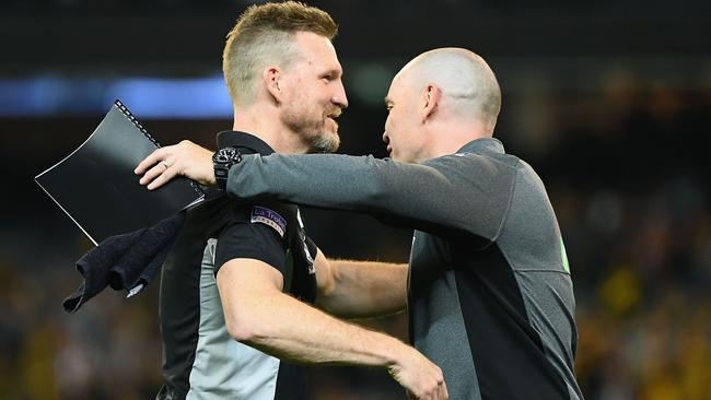 Magpies head coach Nathan Buckley is congratulated by assistant Brenton Sanderson. Picture: Quinn Rooney/Getty Images