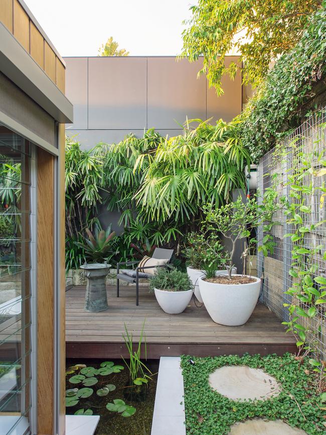 A lounging platform cantilevers over a pond outside the master bedroom. Photos from <i>HomeSpace.</i>