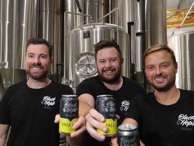 In 2014 three mates got together and brewed an egg nogg beer... that's how the now award winning brewery Black Hops started. Now they have two venues , a small one in Burleigh and a big one in Biggera Waters. Left to right, Dan Norris, Michael "Govs" McGovern, and Eddie Oldfield toast their success. Picture Glenn Hampson.