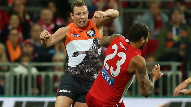 GWS Giants Steve Johnson bumps Sydney's Lance Franklin off the ball during the Round 12 game between GWS and Swans at Spotless Stadium, Homebush. Picture: Toby Zerna