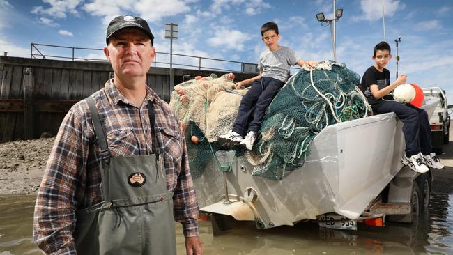 Fisherman Bart Butson with two of his sons, Alex, 12, and Lachlan, 9, at Port Wakefield. AAP Image/Dean Martin.