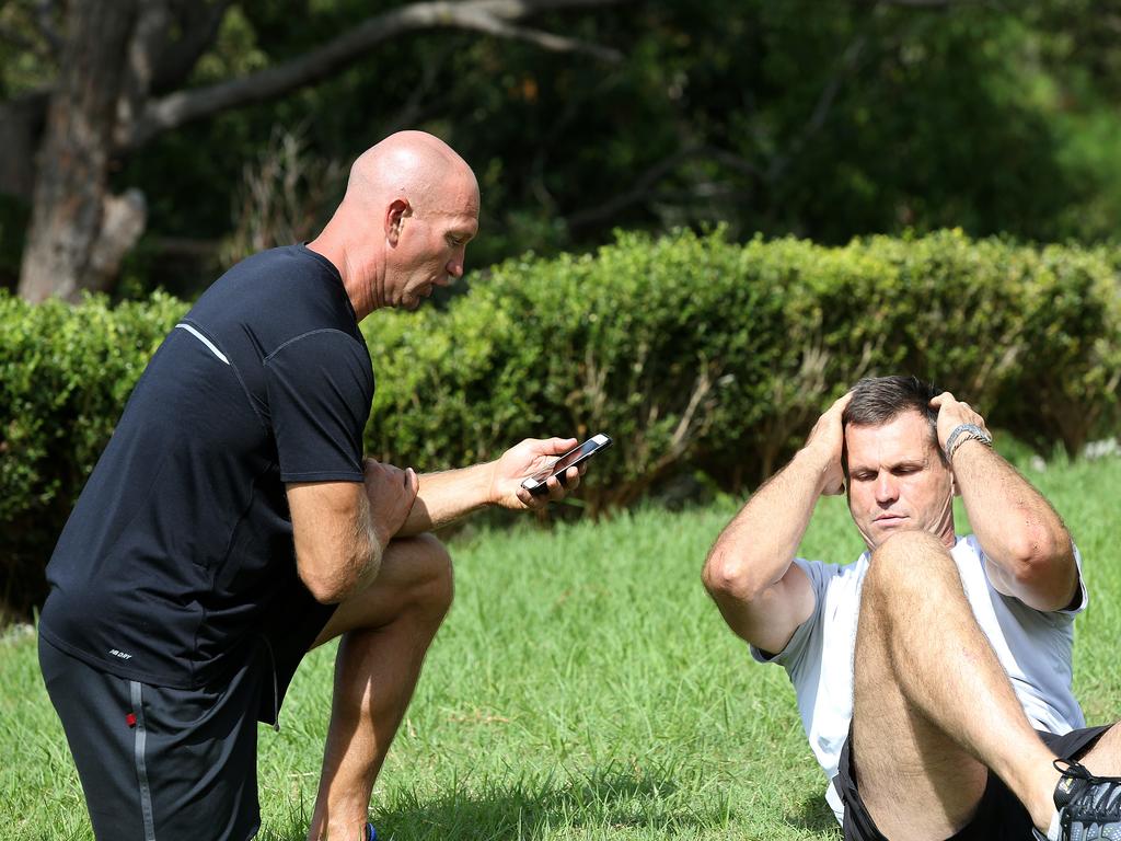 Rugby League legend Paul Harragon is put through his fitness paces by former Knights teammate Adam MacDougall at his Newcastle home. Picture by Peter Lorimer