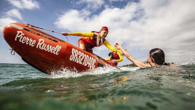 Lifeguards save swimmer in water, 2021. Picture: Surf Life Saving Queensland