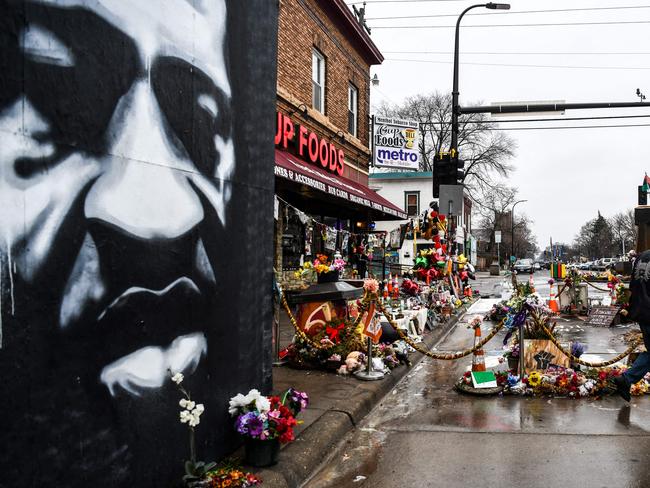 A mural in tribute to George Floyd, left. Picture: AFP