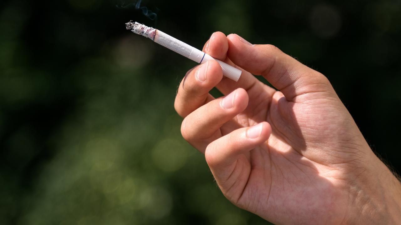 Young man smoking cigarette, inhaling toxic tabacco smoke, smoking kills, warning Picture: istock