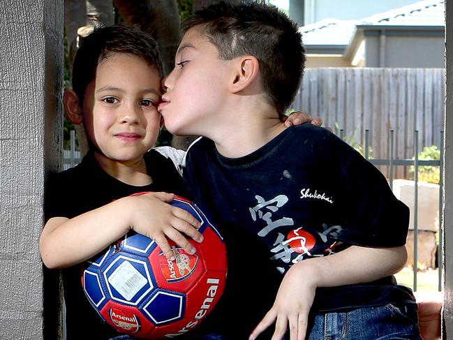 Brothers Kya (5) and Calyn (8) Hoad from Beenleigh having fun with a football. Calyn suffered serious head injuries when he was hit by a car in 2013. Pic Mark Cranitch.