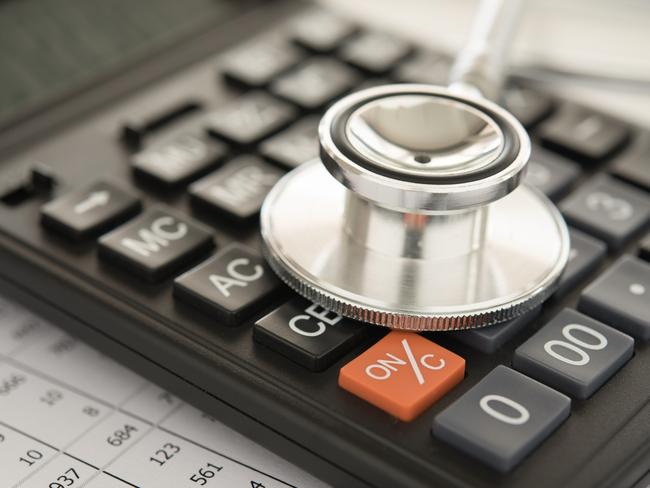 health care costs,  stethoscope and calculator on bills for finance plan or health insurance.