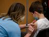 A child, 11, receives the Pfizer-BioNTech Covid-19 vaccine for children in Montreal, Quebec on November 24, 2021. - Today is the first day that children are allowed to receive the version of the vaccine designed for children aged 5 to 11 years old in Canada. (Photo by Andrej Ivanov / AFP)