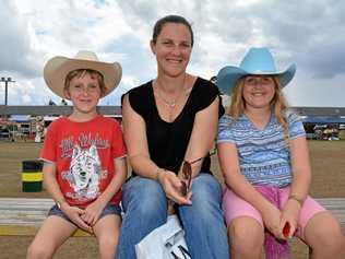 HATS ON: Chelsea, Lachlan and Michelle Howard watch the rope and tie category at the Lowood rodeo. Picture: Meg Bolton