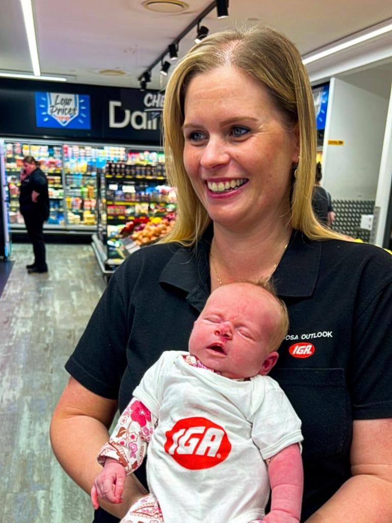 Newborn Hadley is seen wearing an IGA shirt.