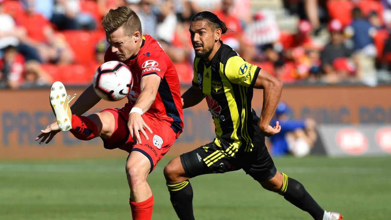 Scott Galloway of United controls the ball ahead of David Williams of the Phoenix. Picture: AAP Image/David Mariuz