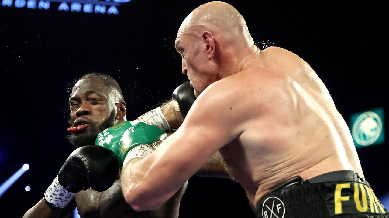 Tyson Fury lands a punch on Deontay Wilder’s chin during their rematch.