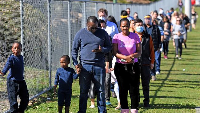 People line up to get COVID-19 tested at the Parklands Christian College in Logan, south of Brisbane, after an employee tested positive. Picture: AAP.