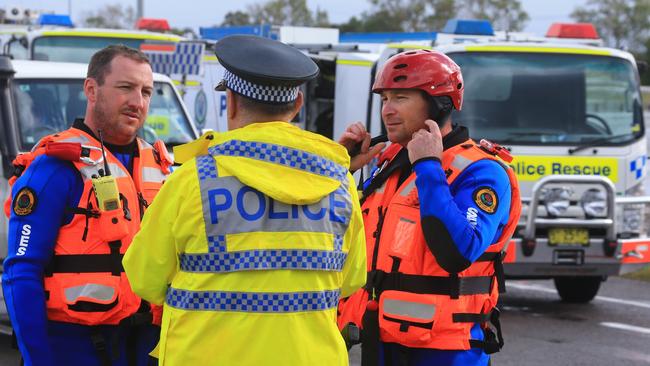 NSW Rescue workers search for a woman swept away in a car from the causeway on Cessnock Road, Maitland. Picture: Adam Taylor