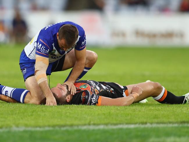 Josh Reynolds attends to Robbie Farah after unintentionally knocking the Tigers veteran unconscious.