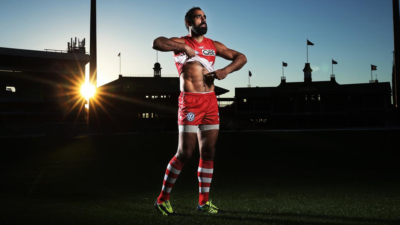 Adam Goodes, in 2013, re-enacts Nicky Winmar’s famous stance against racism. Photo: Phil Hillyard