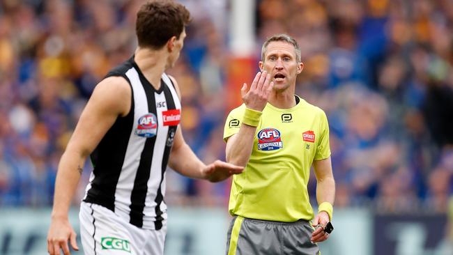 Umpire Shaun Ryan pays a 50-metre penalty against Magpie Brody Mihocek during last year’s grand final.