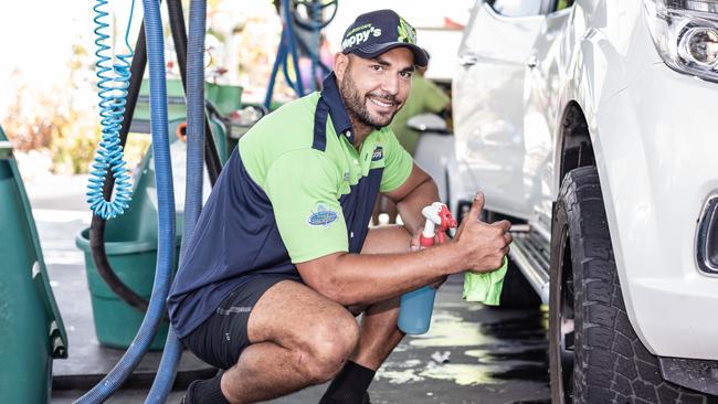 Titans captain Ryan James gets to work cleaning cars.