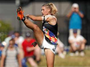 FLYING HIGH: Tayla Harris of the Carlton Blues kicks the ball. This image has quickly become one of the most iconic in Australian sporting history. Picture: Michael Willson/AFL Media