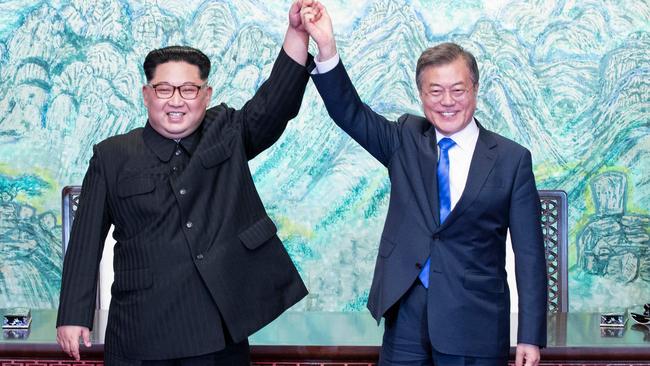 We are the Champions of peace talks. North Korea's leader Kim Jong Un and South Korea's President Moon Jae-in raise their joined hands. Picture: AFP