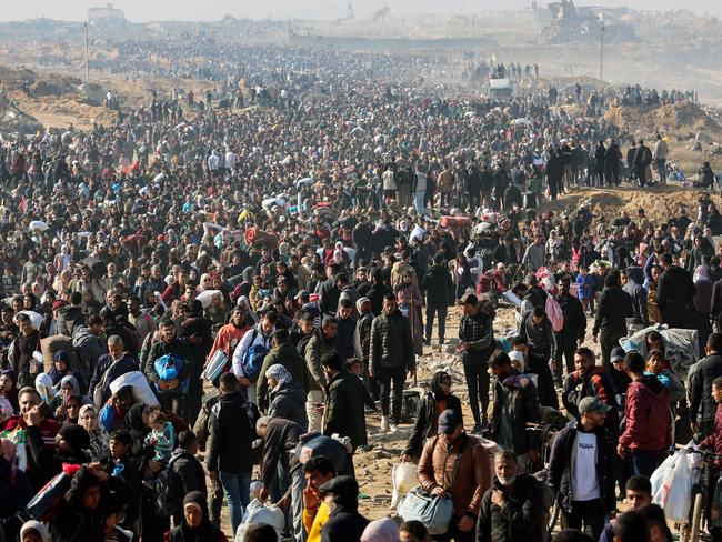 People walk along Gaza's coastal al-Rashid Street to cross the Netzarim corridor from the southern Gaza Strip into the north. Picture: AFP