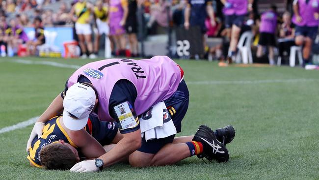 ADELAIDE, AUSTRALIA – MARCH 25: Patrick Parnell of the Crows on the ground and in the hands of trainers after being tackled by Nathan Broad of the Tigers during the 2023 AFL Round 02 match between the Adelaide Crows and the Richmond Tigers at Adelaide Oval on March 25, 2023 in Adelaide, Australia. (Photo by Sarah Reed/AFL Photos via Getty Images)