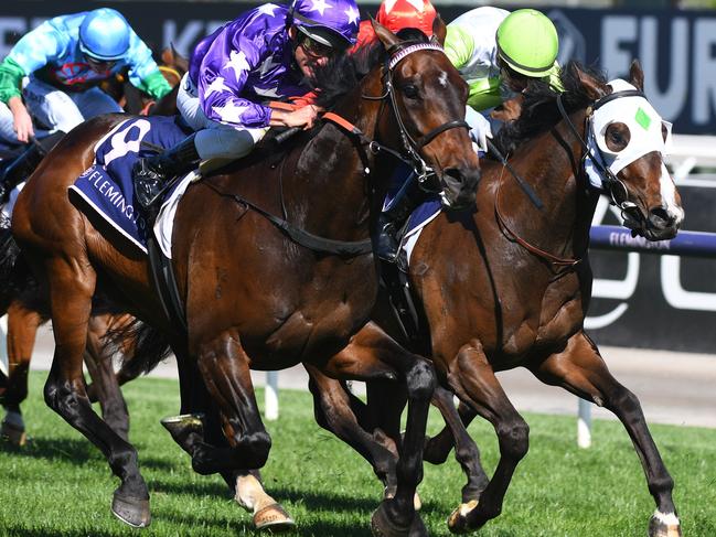 MELBOURNE, AUSTRALIA - NOVEMBER 04: Damien Oliver riding #9 Bermadez wins race 7, the Melbourne Cup Carnival Country Final during 2021 Oaks Day at Flemington Racecourse on November 04, 2021 in Melbourne, Australia. (Photo by Vince Caligiuri/Getty Images)