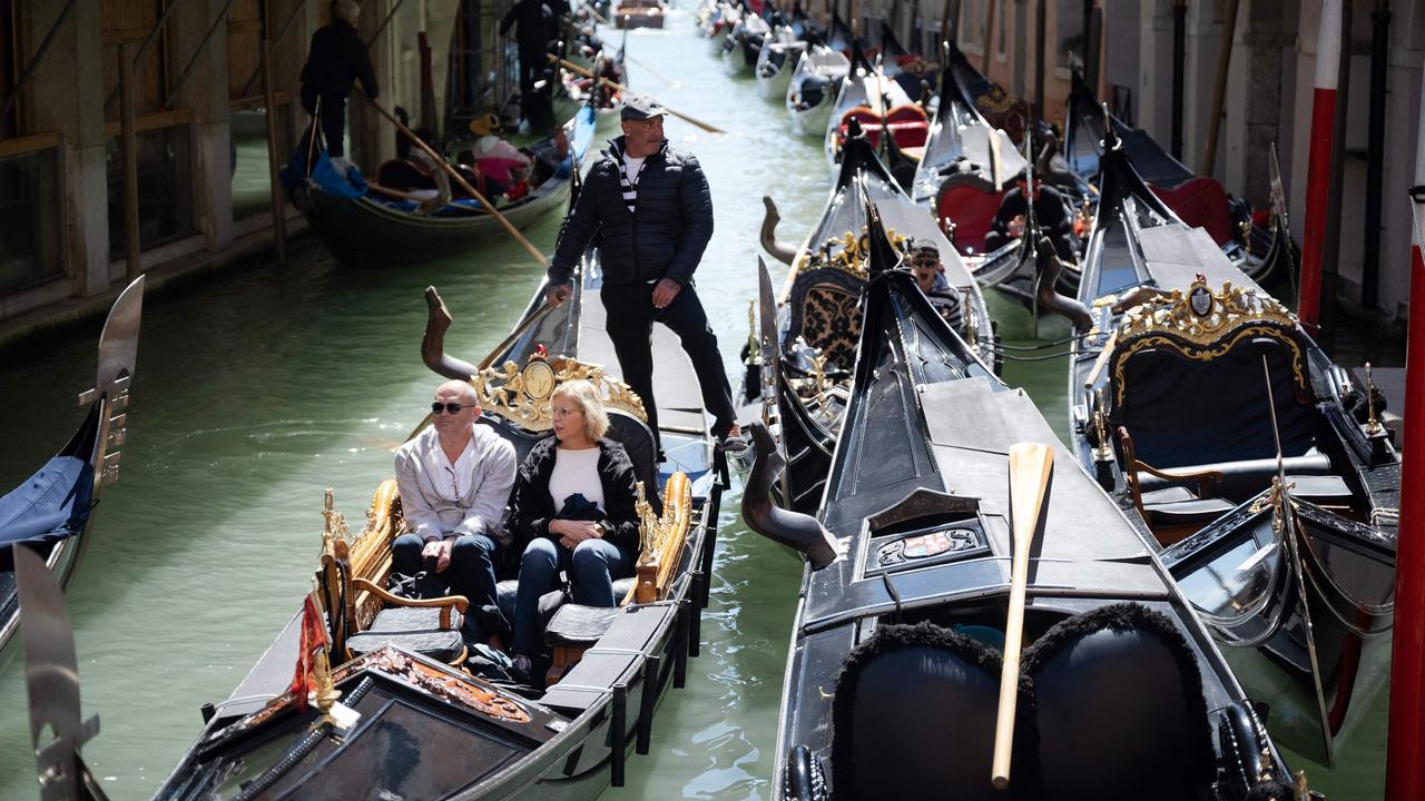 Many locals like those who take people on gondoliers would not have work if it wasn’t for tourists. Picture: Marco Bertorello / AFP