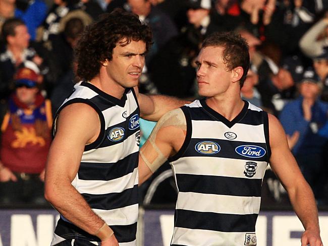 Matthew Scarlett and Joel Selwood celebrate after a win.