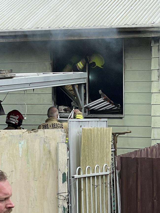 Firefighters gaining access to the smouldering unit at Dudley. Pic: Amy Ziniak