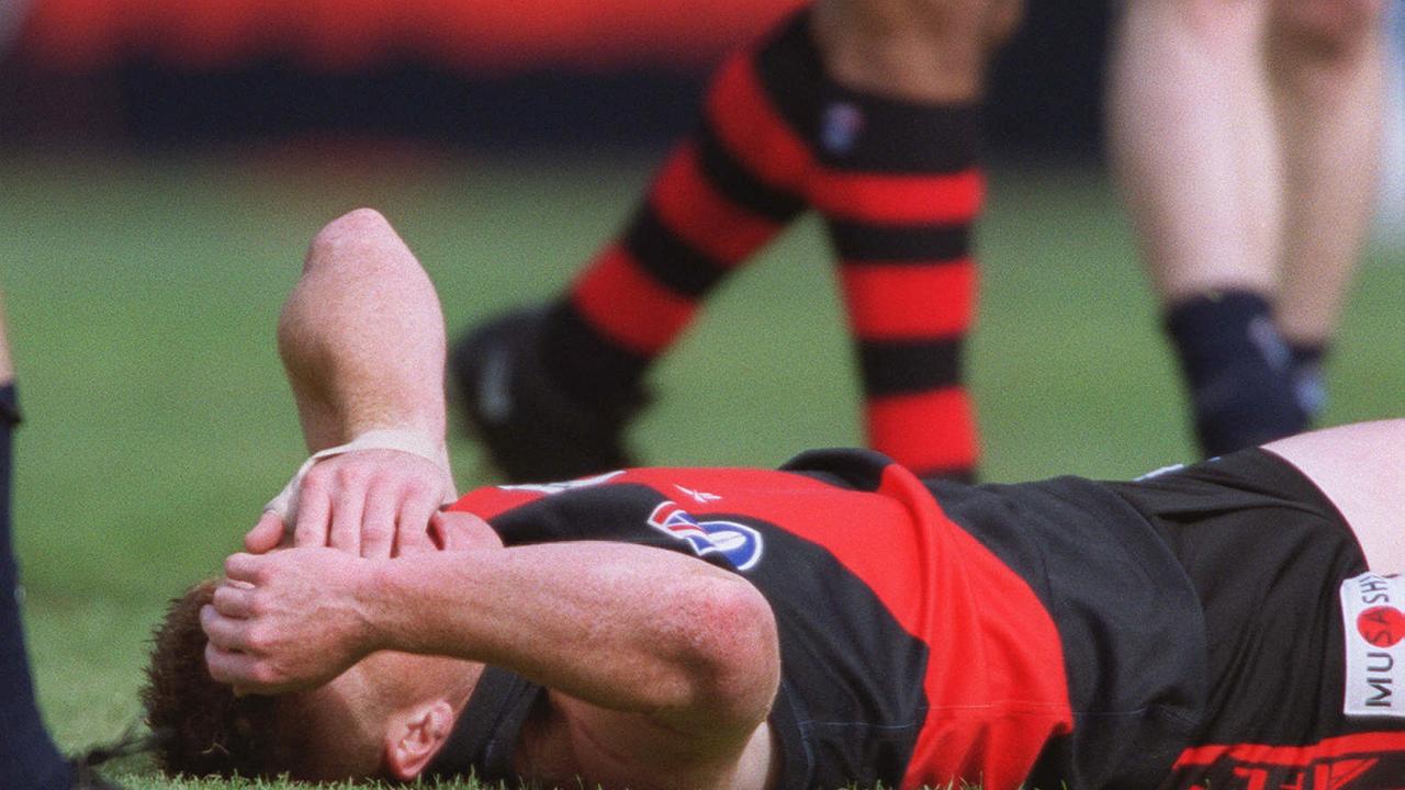 Essendon's Gary Moorcroft on the ground in agony after the upset loss.