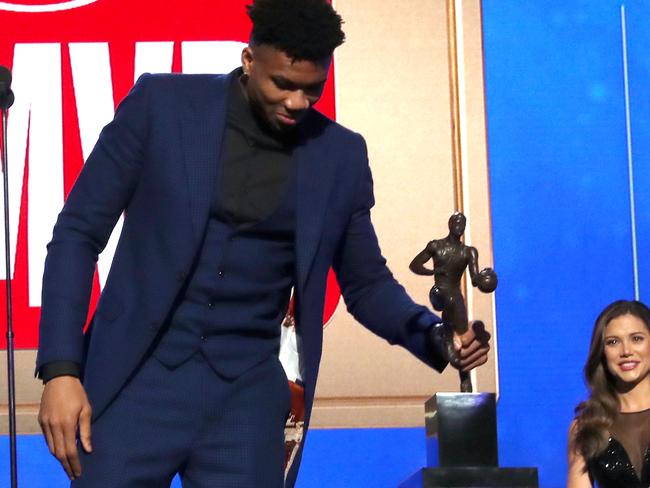 Giannis accepts the NBA MVP trophy.