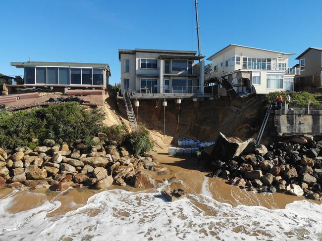 Homes were left teetering on the edge, while some partly crumbled, after July storms. Picture: David Swift